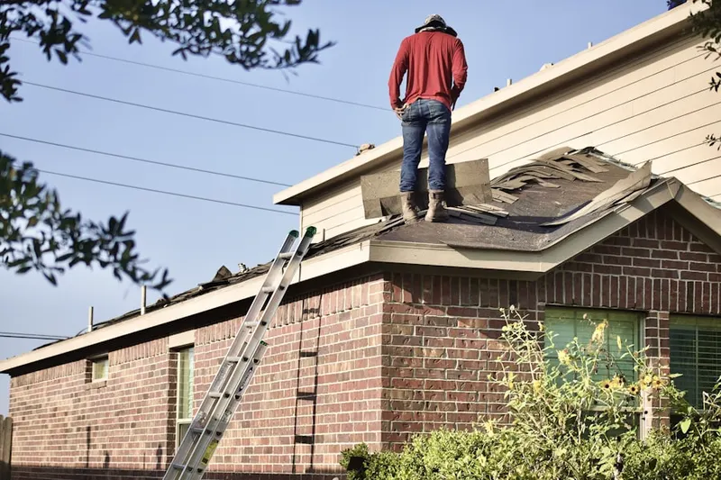 Professional roofer working on a residential roof in East Pembroke